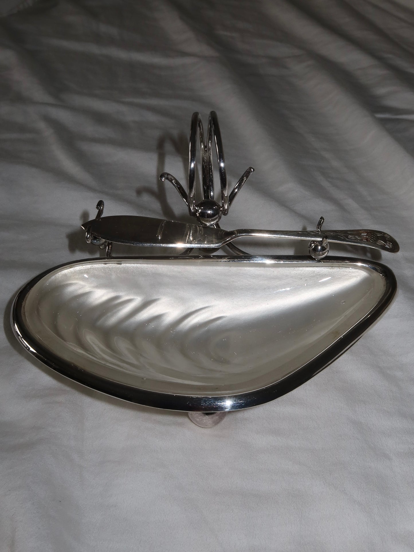 An Antique English caviar bowl in silver-plated metal with glass insert.