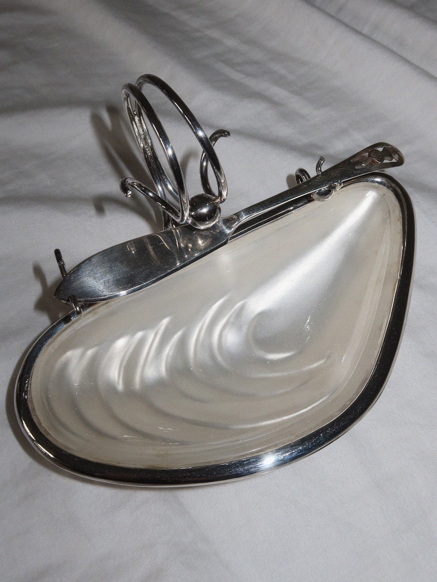 Antique English caviar bowl in silver-plated metal with glass insert.