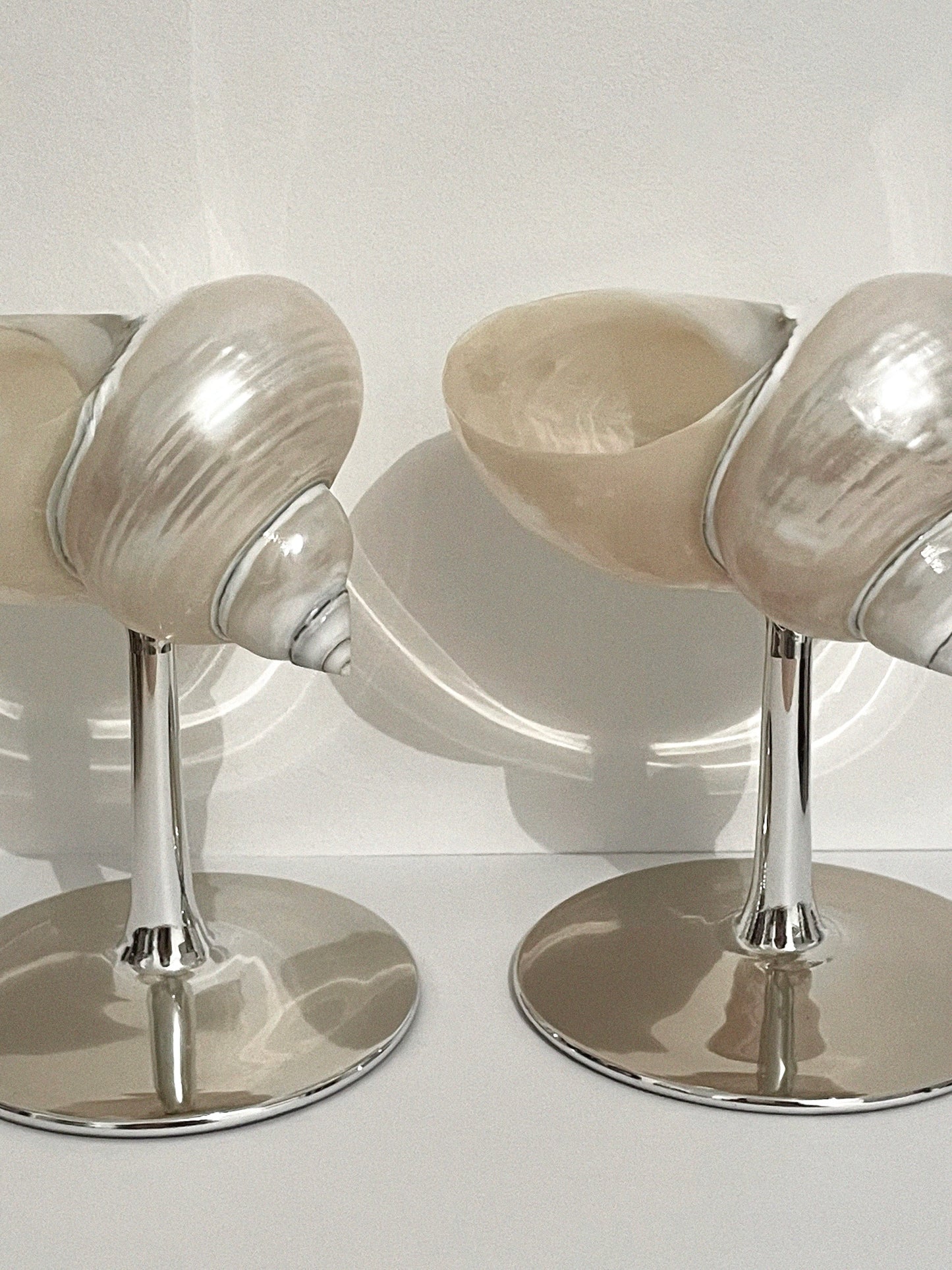A set of two curly shell glass with silver plated stem.
