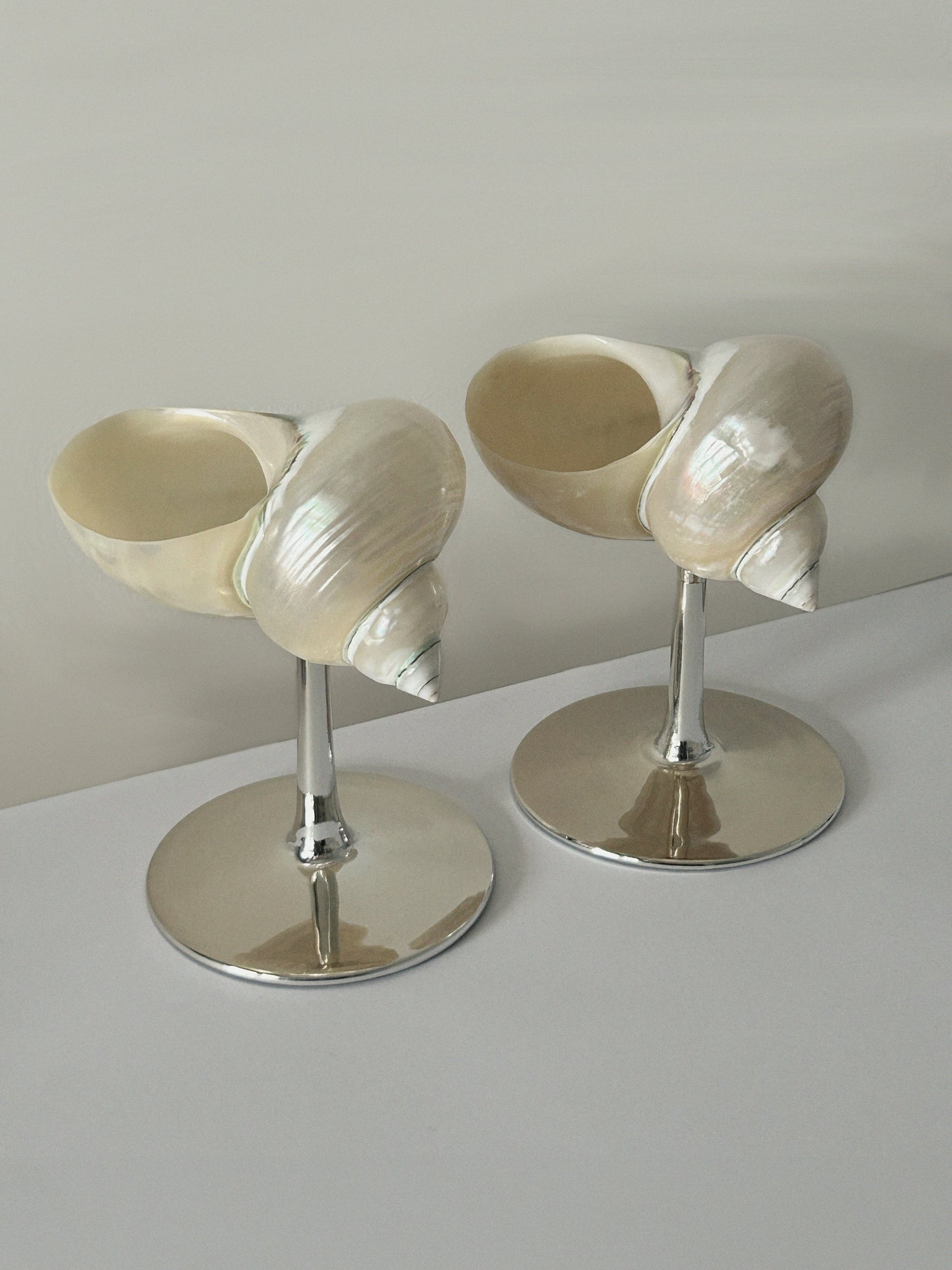 Set of two curly shell glass with silver plated stem.